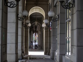 Looking through arches from the entrance of a condo, towards 45 The Esplanade, a hotel leased by the city to serve as a shelter for homeless individuals in Toronto, Ont. on Thursday, June 23, 2022.