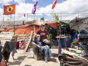 Will House and Jen Draper are photographed outside their home at a large homeless encampment, in Kitchener, Ont., on Monday June 27, 2022.