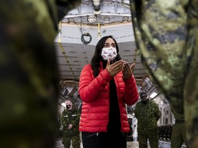 Defence Minister Anita Anand speaks to military personnel after getting a tour of the CC 177 Globemaster aircraft at Canadian Forces Base Trenton, in Trenton, Ont., Thursday, April 14, 2022.&ampnbsp;The parliamentary budget officer says the federal government would need to spend an additional $75.3 billion on defence over the next five years for Canada to reach NATO's target of two per cent of GDP.