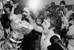 In this Sunday, May 19, 1974 file photo, Philadelphia Flyers goalie Bernie Parent pours champagne into the Stanley Cup after the Flyers won the NHL Championship over the Boston Bruins in Philadelphia. CP