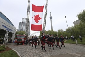 Toronto Fire Service Pipes and Drums lead the procession on Sunday, June 12, 2022. JACK BOLAND/TORONTO SUN