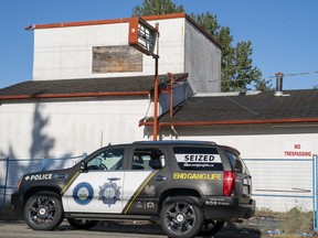 A vehicle belonging to The Combined Forces Special Enforcement Unit of B.C. sits in front of the former Nanaimo Hells Angels clubhouse in Nanaimo.