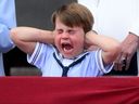 Prince Louis of Cambridge reacts as he watches a special flypast from Buckingham Palace balcony following the Queen's Birthday Parade, the Trooping the Colour, as part of Queen Elizabeth II's platinum jubilee celebrations, in London on June 2, 2022. 