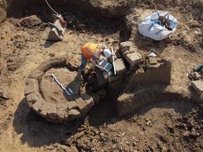 A person works on a site where archaeologists discovered a Roman temple in Zevenaar, central-east Netherlands May 4, 2022.