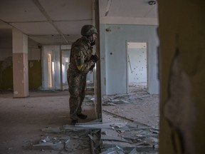 A Ukrainian soldier stands guard during intense fighting on the front line in Severodonetsk, Luhansk Region, Ukraine, Wednesday, June 8, 2022.