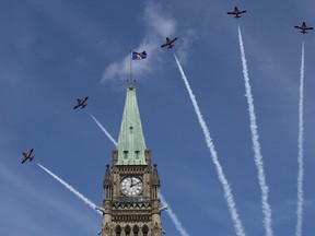 Royal Canadian Air Force Snowbirds fly past the Peace Tower during the Canada Day noon show on Parliament Hill in Ottawa on Monday, July 1, 2019.&ampnbsp;The Department of National Defence says the Canadian Forces Snowbirds will be unable to fly in planned air shows and fly pasts until a technical issue is resolved.