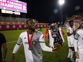 Jun 4, 2022; Toronto, Ontario, Canada; Toronto FC forward Ayo Akinola walks with the Voyageurs Cup after defeating Forge FC at Tim Hortons Field.