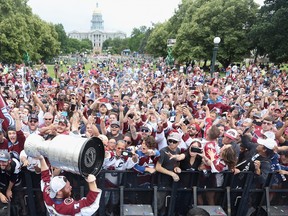 J.T. Compher of the Colorado Avalanche lifts the Stanley Cup for fans during the Colorado Avalanche Victory Parade and Rally at Civic Center Park on June 30, 2022 in Denver.