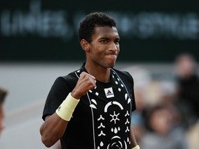 Canada's Felix Auger-Aliassime clenches his fist after scoring a point against Spain's Rafael Nadal during their fourth round match at the French Open tennis tournament in Roland Garros stadium in Paris, France, Sunday, May 29, 2022.