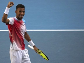 Felix Auger-Aliassime celebrates after defeating Marin Cilic of Croatia in their fourth round match at the Australian Open tennis championships in Melbourne, Australia, Monday, Jan. 24, 2022.