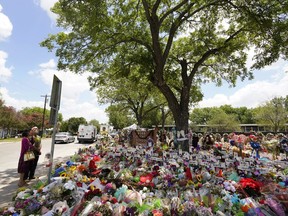 Pecan trees, planted in the 1960's, shade a memorial created to honor the victims killed in the recent school shooting at Robb Elementary, Thursday, June 9, 2022, in Uvalde, Texas.