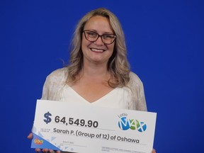 Sarah Pruesse of Oshawa holds her family cheque from the Feb. 4, 2022 Lotto Max draw.