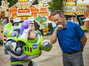 In this handout image provided by Walt Disney World Resort, actor Tim Allen and Buzz Lightyear calls Star Command, during a special preview of Toy Story Land at Disney's Hollywood Studios on Wednesday, June 27, 2018, in Lake Buena Vista, Fla.