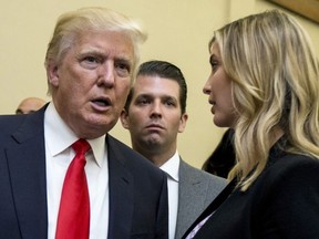 Donald Trump, left, his son Donald Trump Jr., centre, and his daughter Ivanka Trump speak during the unveiling of the design for the Trump International Hotel in the The Old Post Office, in Washington, Sept. 10, 2013.