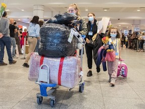 Ukrainian nationals arrive at Trudeau Airport in Montreal, Sunday, May 29, 2022.