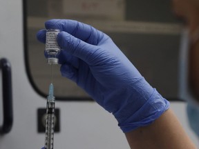 A vial of the Phase 3 Novavax coronavirus vaccine is seen ready for use in the trial at St. George's University hospital in London, Oct. 7, 2020.