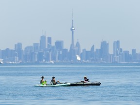 People enjoy activities on Lake Ontario overlooking the Toronto skyline.