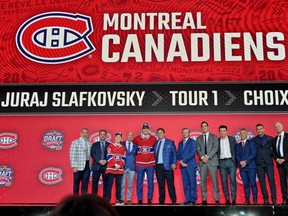 Juraj Slafkovsky and Montreal Canadiens leaders pose on the stage after he was selected as the No. 1  pick at the 2022 NHL entry draft at Bell Centre in Montreal.