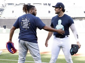 Vladimir Guerrero Jr. of the Toronto Blue Jays (left) greets former teammate Robbie Ray, now of the Seattle Mariners, before a game at T-Mobile Park on July 7, 2022 in Seattle, Washington.