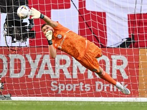 Chicago Fire FC goalkeeper Gaga Slonina redirects a Toronto FC shot away from the net with his fingertips in the first half at Soldier Field on July 13, 2022.