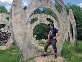 Peter Camani with just one of the Screaming Head monoliths he's created on his property in Ryerson Township, Ontario.