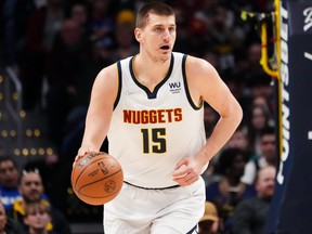 Nikola Jokic of the Denver Nuggets dribbles up the court while bleeding against the Memphis Grizzlies at Ball Arena on April 7, 2022 in Denver, Colorado.