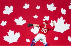 Alejandro Kirk of the Blue Jays warms up in front of Canada Day decorations before playing the Tampa Bay Rays at the Rogers Centre on July 1, 2022, in Toronto. MARK BLINCH/GETTY IMAGES