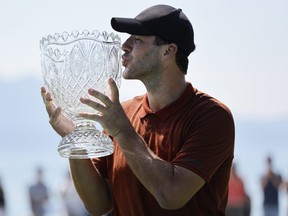 Former NFL quarterback Tony Romo kisses the trophy after winning the American Century Championship at Edgewood Tahoe Golf Course on July 10, 2022 in Stateline, Nevada.