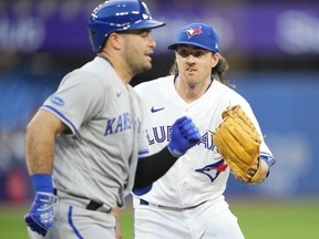 Kevin Gausman of the Toronto Blue Jays tags out Sebastian Rivero of the Kansas City Royals in the fifth inning during their MLB game at the Rogers Centre on July 14, 2022 in Toronto, Ontario, Canada.