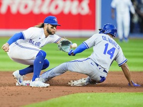 Edward Olivares of the Kansas City Royals is out trying to steal second base against Bo Bichette of the Toronto Blue Jays in the third inning during their MLB game at the Rogers Centre on July 14, 2022 in Toronto, Ontario, Canada.