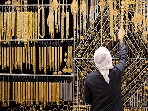 A salesman arranges gold jewelry at Dubai Gold Souk on Nov. 25, 2020 in Dubai, United Arab Emirates.