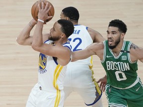 Jayson Tatum #0 of the Boston Celtics defends the shot attempt by Stephen Curry #30 of the Golden State Warriors during the first quarter in Game One of the 2022 NBA Finals at Chase Center on June 2, 2022 in San Francisco.