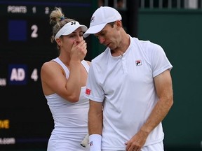 Gabriela Dabrowski of Canada and partner John Peers of Australia interact during their Mixed Doubles First Round match against Ariel Behar of Uruguay and Demi Schuurs of Netherlands on day six of The Championships Wimbledon 2022 at All England Lawn Tennis and Croquet Club on July 02, 2022 in London, England.
