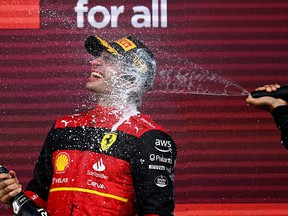 Race winner Carlos Sainz of Spain and Ferrari celebrates on the podium during the F1 Grand Prix of Great Britain at Silverstone on July 3, 2022 in Northampton, England.