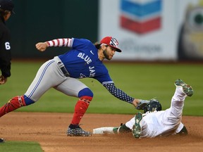Ramon Laureano #22 of the Oakland Athletics is tagged out stealing from Bo Bichette #11 of the Toronto Blue Jays in the bottom of the seventh inning against at RingCentral Coliseum on July 04, 2022 in Oakland, California.