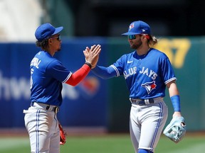 Bo Bichette and Santiago Espinal of the Toronto Blue Jays celebrate after a win against the Oakland Athletics at RingCentral Coliseum on July 06, 2022 in Oakland, California.