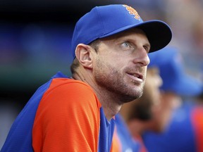 Max Scherzer #21 of the New York Mets looks on from the dugout during the third inning against the Miami Marlins at Citi Field on July 07, 2022 in New York City.