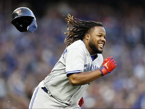 Vladimir Guerrero Jr. #27 of the Toronto Blue Jays loses his helmet as he runs to first base  during the fifth inning against the Seattle Mariners at T-Mobile Park on Friday.