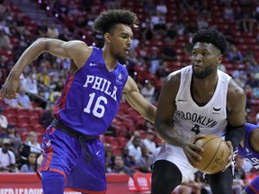 RaiQuan Gray of the Brooklyn Nets drives against Charlie Brown Jr. of the Philadelphia 76ers during the 2022 NBA Summer League at the Thomas & Mack Center on July 10, 2022 in Las Vegas, Nevada.