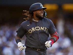 Vladimir Guerrero Jr. #27 of the Toronto Blue Jays smiles as he runs to first base during the 92nd MLB All-Star Game presented by Mastercard at Dodger Stadium on July 19, 2022 in Los Angeles, California.