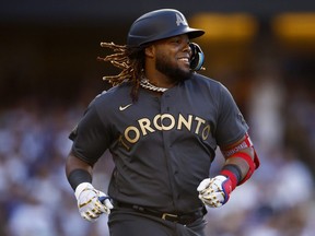 Vladimir Guerrero Jr. of the Toronto Blue Jays smiles as he runs to first base during the 92nd MLB All-Star Game presented by Mastercard at Dodger Stadium on July 19, 2022 in Los Angeles, California.