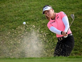 Brooke M. Henderson of Canada plays a shot from a bunker on the 18th hole on day two of The Amundi Evian Championship at Evian Resort Golf Club on July 22, 2022 in Evian-les-Bains, France.