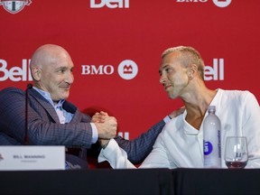 Toronto FC president Bill Manning shakes hands with the football club's newest player Federico Bernardeschi during a news conference.