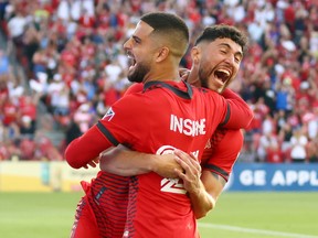 Toronto FC's Jonathan Osorio and Lorenzo Insigne celebrate a goal against Charlotte FC at BMO Field on Saturday.