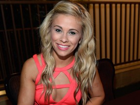 MMA fighter Paige Vanzant signs an autograph for fans during Metro PCS Presents Wyclef Jean Powered by PANDORA at The Boulevard Pool at The Cosmopolitan of Las Vegas on July 9, 2015 in Las Vegas, Nevada.
