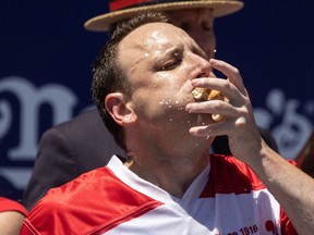 Joey Chestnut eats as he competes for his 15th championship title during the 2022 Nathan's Famous Fourth of July hot dog eating contest on Coney Island on July 4, 2022 in New York.