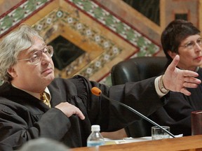 Judge Alex Kozinski, of the 9th U.S. Circuit Court of Appeals, gestures during oral arguments in San Francisco, Sept. 22, 2003.