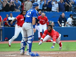 Jul 16, 2022; Toronto, Ontario, CAN;  Toronto Blue Jays pinch hitter Raimel Tapia dives in to score the winning run against the Kansas City Royals in the 10th inning at the  Rogers Centre.