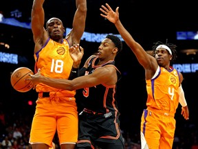 New York Knicks guard RJ Barrett (9) passes the ball against Phoenix Suns centre Bismack Biyombo (18) and guard Aaron Holiday (4) during the second half at Footprint Center March 4, 2022.