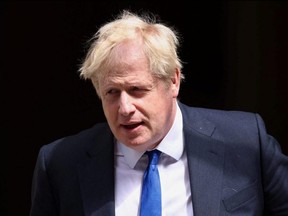 British Prime Minister Boris Johnson walks at Downing Street in London, Wednesday, July 6, 2022.